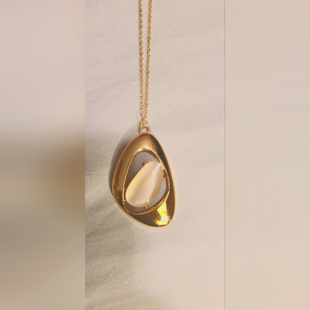 Long gold necklace with moon stone in center